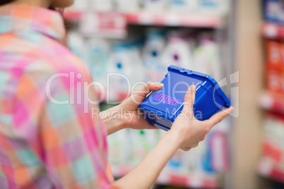 Close up view of hands holding detergent