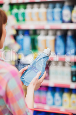 Over shoulder view of woman holding detergent