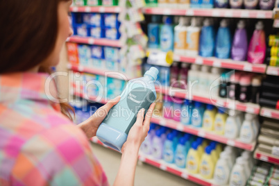 Rear view of woman holding detergent