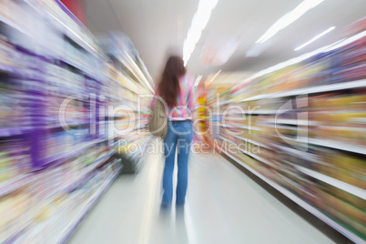 Rear view of woman standing in aisle with blurred effects