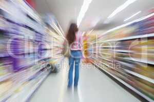 Rear view of woman standing in aisle with blurred effects