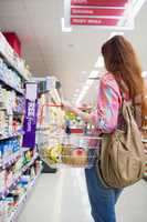 Woman doing grocery shopping with shopping basket