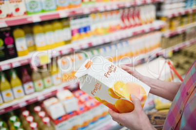 Close up view of hands holding fruits juice