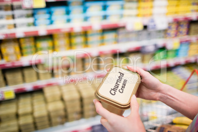 Close up view of hands holding churned cream