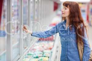 Concentrated woman buying frozen food