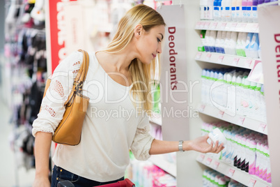 Side view of woman choosing deodorant