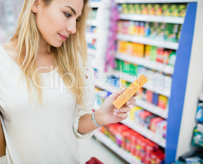 Profile view of woman holding a product
