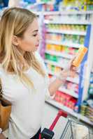 Profile view of woman holding a product