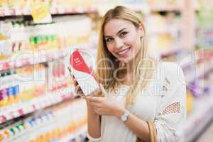 Smiling customer with a bottle of fruit juice