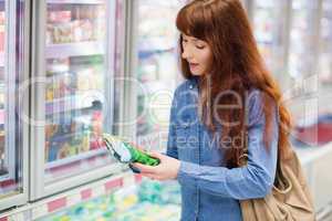 Customer picking a product in the frozen aisle