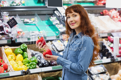 Smiling customer holding peppers