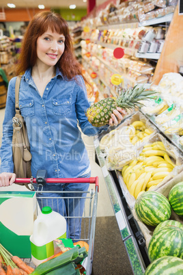 Smiling customer holding a pineapple