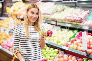 Customer at supermarket front of fruits shelf