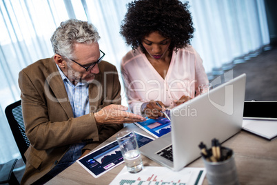 Two businessmen working on a computer