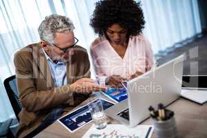 Two businessmen working on a computer