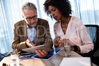 Two businessmen using a tablet computer