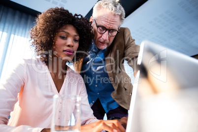 Two businessmen working on a computer