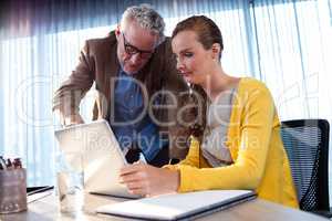 Two businessmen working on a computer