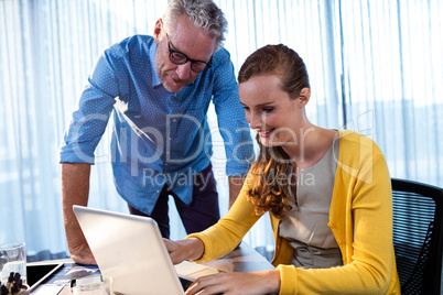 Two businessmen working on a computer