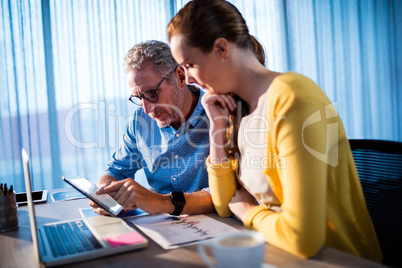 Two businessmen using a tablet computer