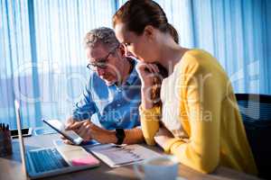 Two businessmen using a tablet computer