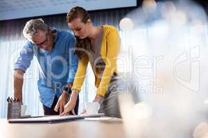 Two businessmen pointing at documents