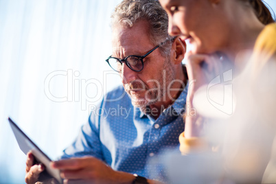 Two businessmen using a tablet computer