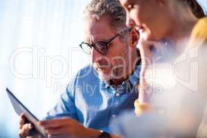 Two businessmen using a tablet computer