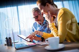 Two businessmen using a tablet computer