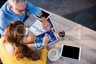 Two businessmen analyzing documents