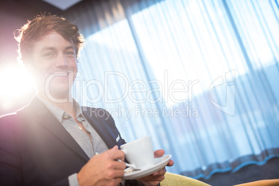 Smiling businessman with coffee