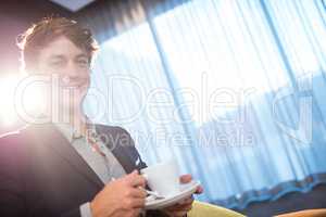 Smiling businessman with coffee