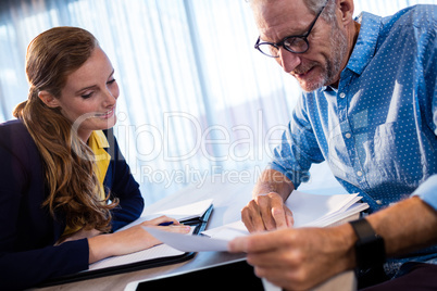 Two businessmen reading a document