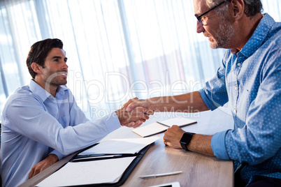 Two businessmen giving a handshake