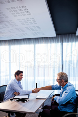 Two businessmen giving a handshake