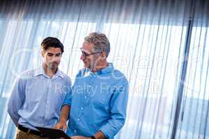 Two businessmen using a tablet computer