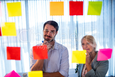 Businessmen reading post it