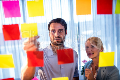 Businessmen reading post it