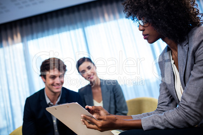 Business people having a discussion around a tablet computer