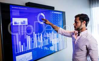 Businessman analyzing data with a touch screen