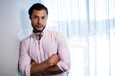 Handsome businessman posing with crossed arms