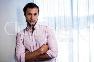 Handsome businessman posing with crossed arms