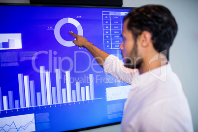 Side view of businessman using touch screen