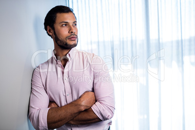 Handsome businessman looking away while posing