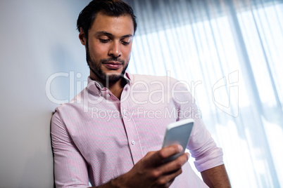 Attractive businessman using smartphone