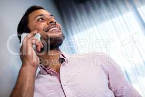 Focus on smiling businessman calling with smartphone