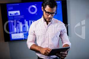 Serious businessman using tablet computer