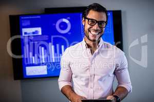 Handsome businessman standing and smiling