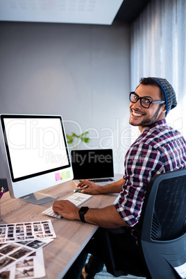 Portrait of casual man working at computer desk Portrait of casual man working at computer desk