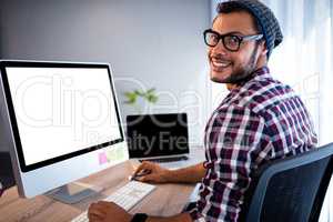 Portrait of casual man working at computer desk